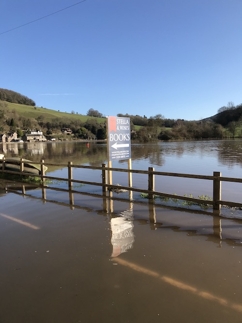 The new Stella Books sign surrounded by water in recent high tides.